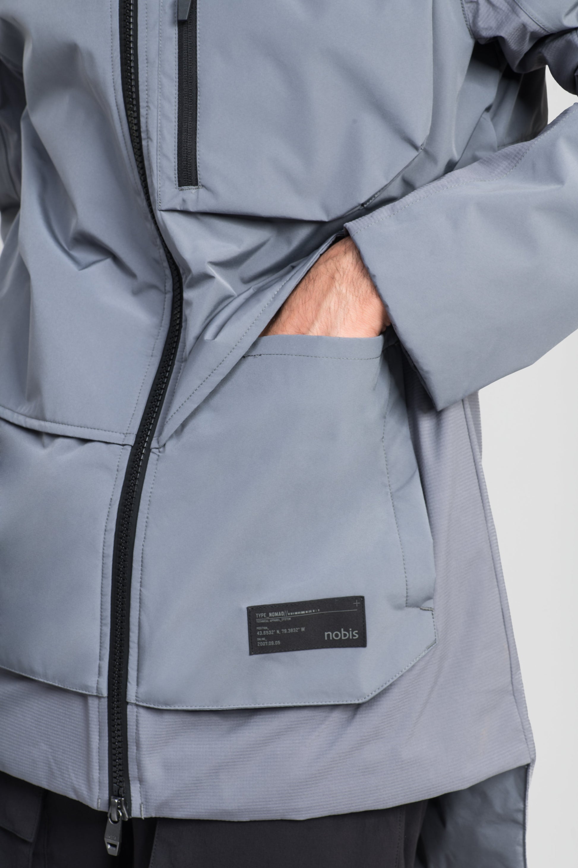 Alta Men's Performance Shell Jacket in hip length, Primaloft Gold Insulation Active+, chest and waist pockets, ventilation under arms, reflective detailing on hood and back, two-way front zipper, and non-removable hood with adjustable drawstrings, in Concrete