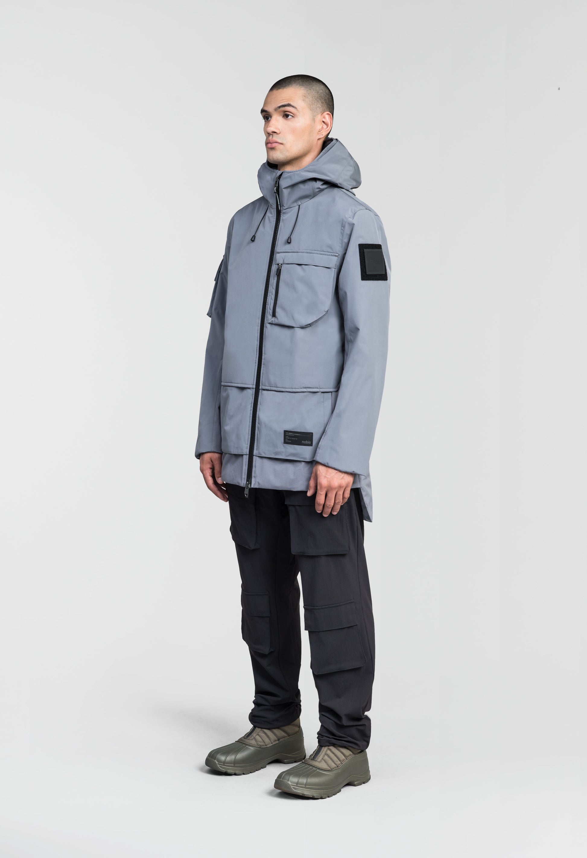 Alta Men's Performance Shell Jacket in hip length, Primaloft Gold Insulation Active+, chest and waist pockets, ventilation under arms, reflective detailing on hood and back, two-way front zipper, and non-removable hood with adjustable drawstrings, in Concrete