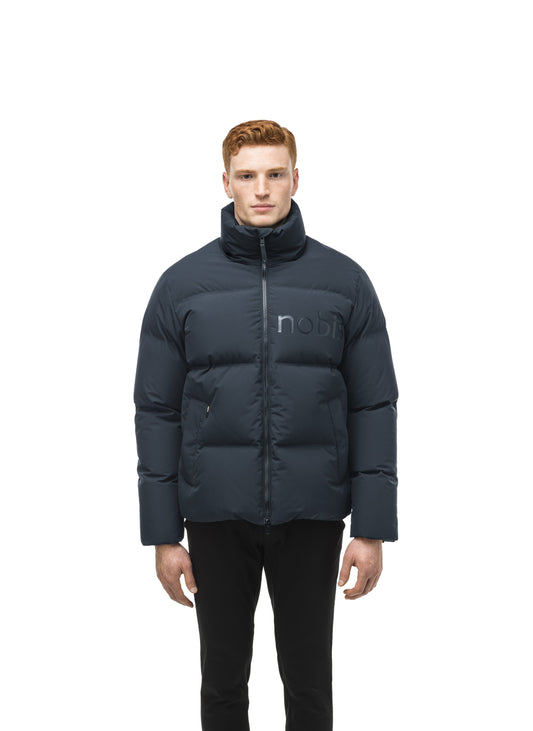 Men's puffer jacket with a minimalist modern design; featuring graphic details like oversized tonal branding, an exposed zipper, and seamless puffer channels in Midnight Blue + Midnight Blue