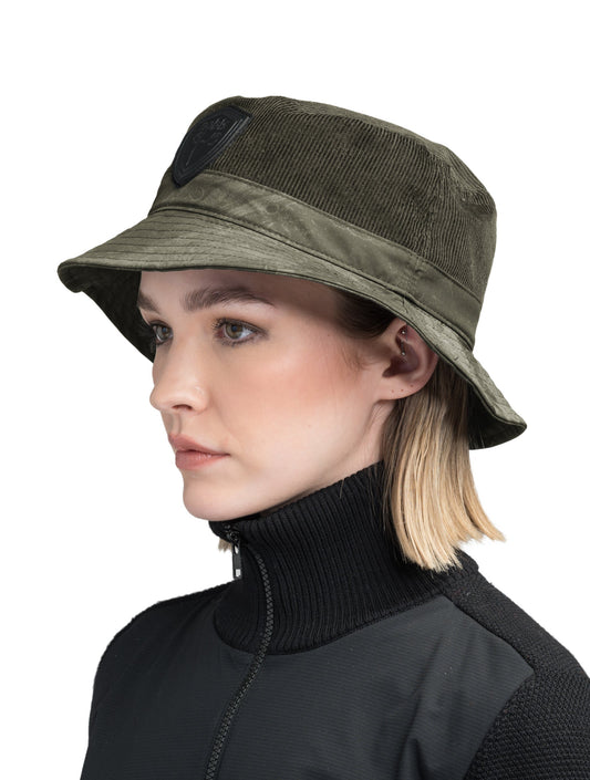 Kaia Unisex Tailored Bucket Hat in a 100% cotton corduroy and 3-ply micro denier fabrication, unstructured crown, black leather Nobis shield logo on crown front, and small flap pocket on the right side crown, in Fatigue