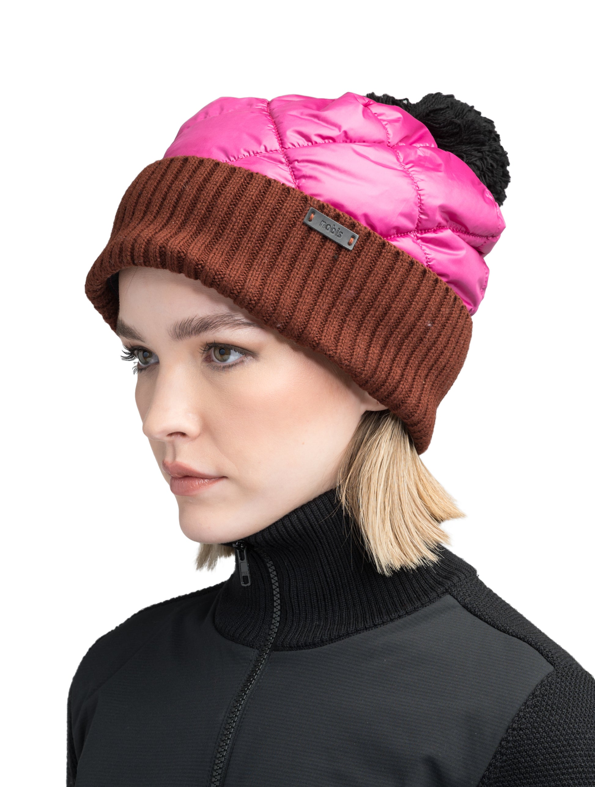 Lany Unisex Hybrid Pom Beanie in an extra fine merino wool blend and premium cire technical taffeta fabrication, rib knit cuff with leather Nobis wordmark detailing, quilted body, and plush pom-pom finish, in Festival Fuschia