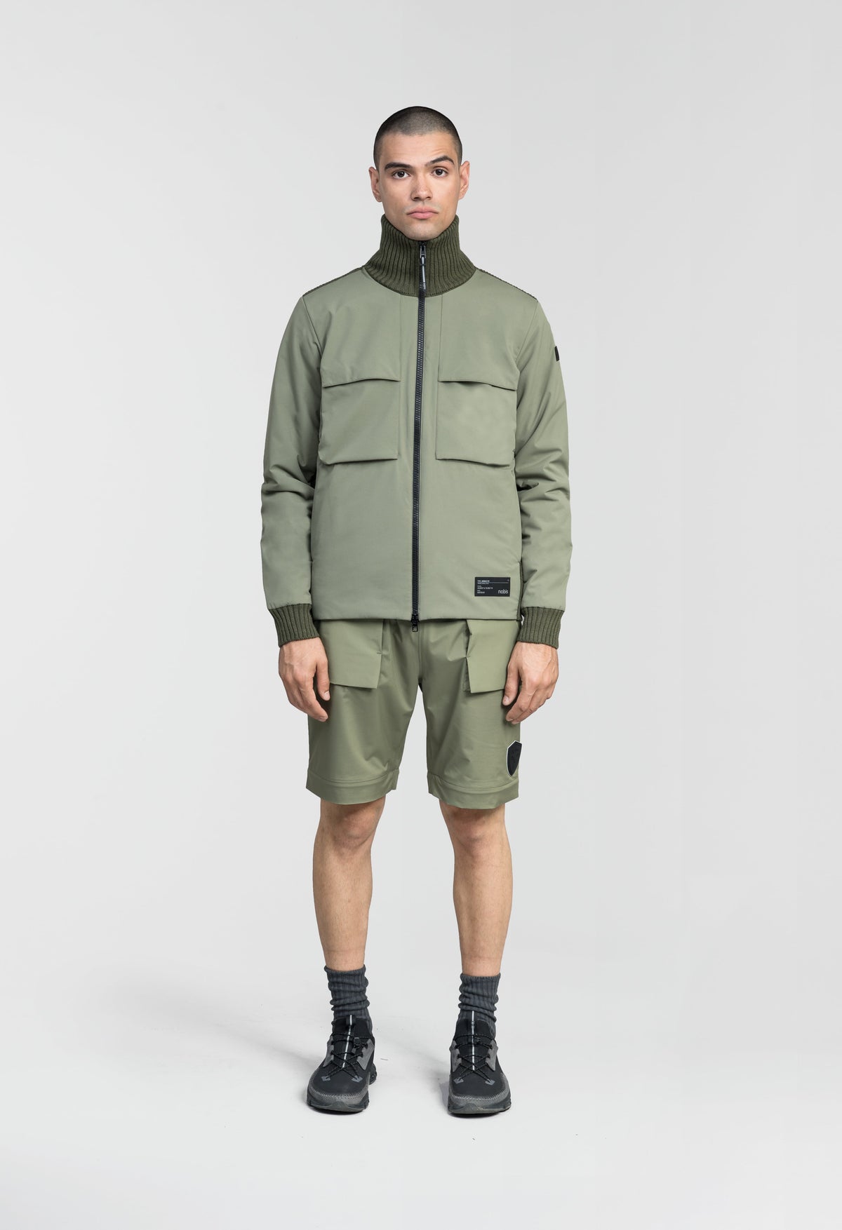 Layton Men's Tactical Hybrid Sweater in hip length, Primaloft Gold Insulation Active+, Merion wool knit collar, sleeves, back, and cuffs, two-way front zipper, and pockets at chest and waist, in Clover