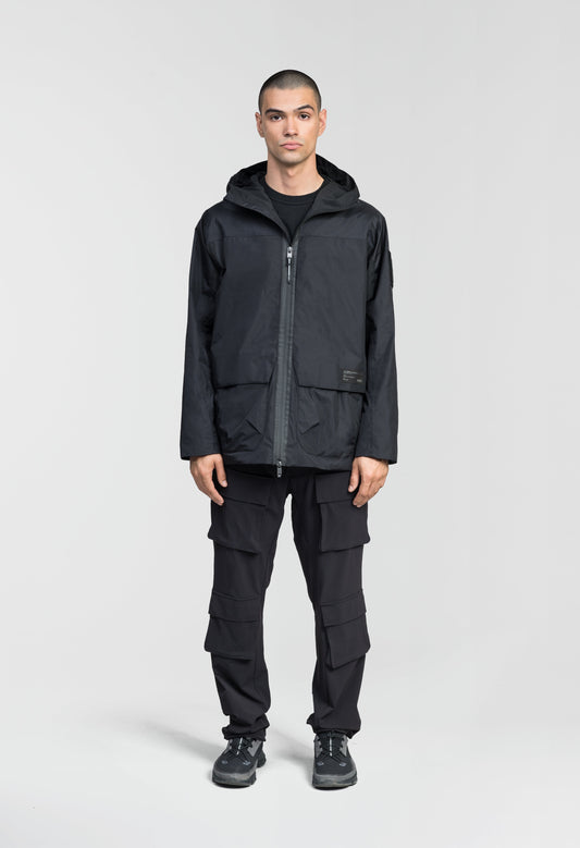 Mission Men's Performance Rain Shell Jacket in hip length, non-removable hood with adjustable toggle, two-way waterproof zipper, flap closure waist pockets with additional side entry storage, zipper ventilation on back, passive underarm ventilation, and breathable mesh lining, in Black