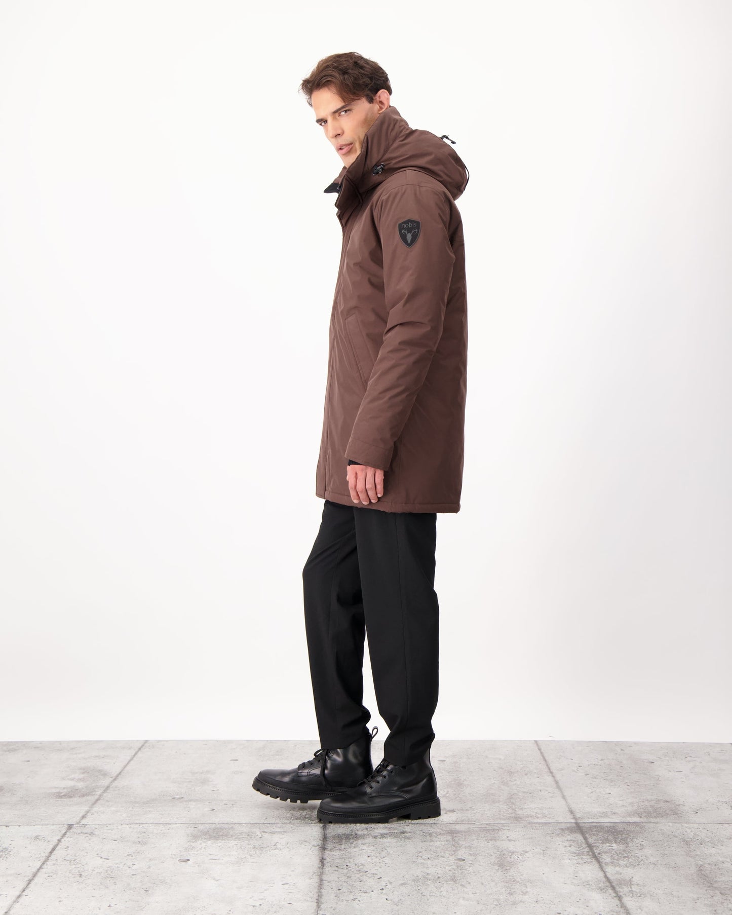 Pierre Men's Jacket in thigh length, Canadian white duck down insulation, non-removable down-filled hood, angled waist pockets, centre-front zipper with wind flap, and elastic ribbed cuffs, in 3L Coffee Bean