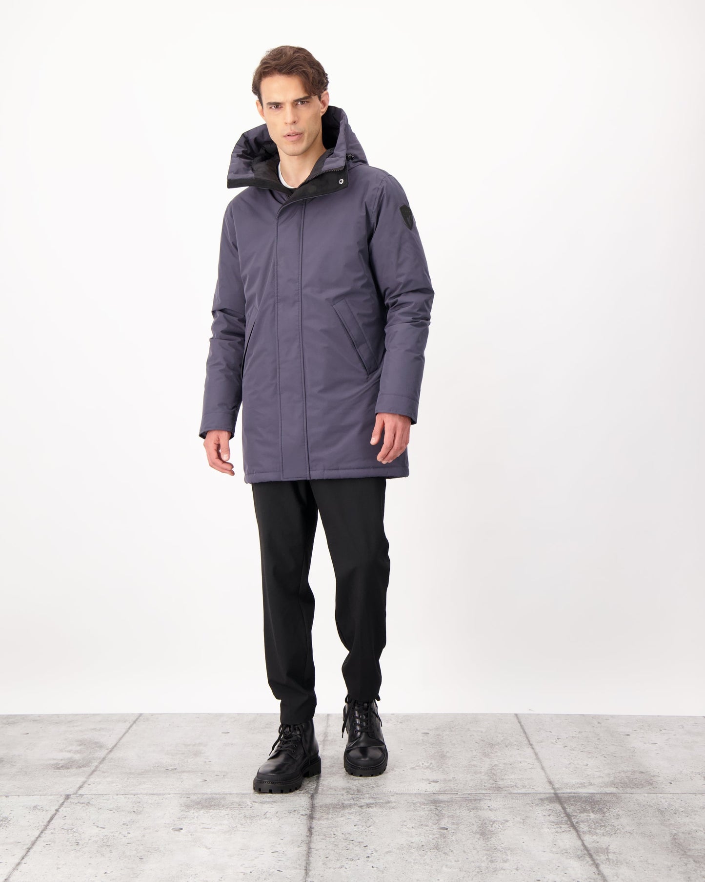 Pierre Men's Jacket in thigh length, Canadian white duck down insulation, non-removable down-filled hood, angled waist pockets, centre-front zipper with wind flap, and elastic ribbed cuffs, in 3L Navy