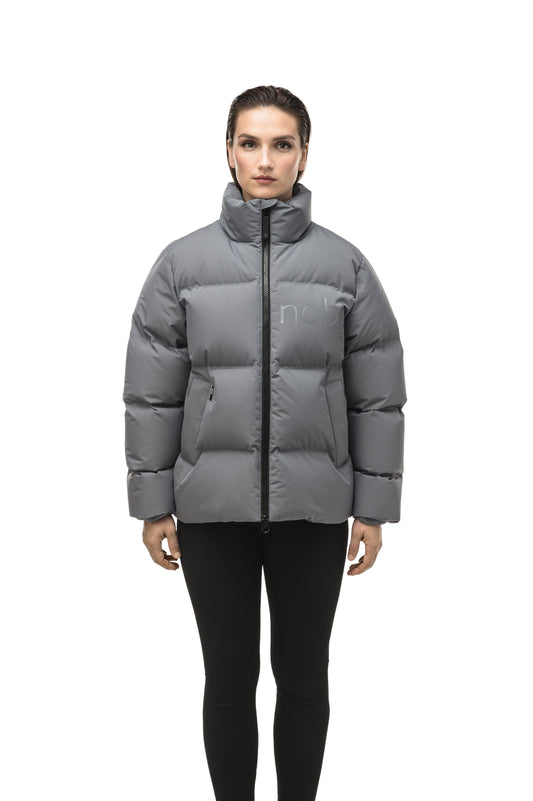 Women's puffer jacket with a minimalist modern design; featuring graphic details like oversized tonal branding, an exposed zipper, and seamless puffer channels to lock in the Premium Canadian Origin White Duck Down in Concrete color + Concrete