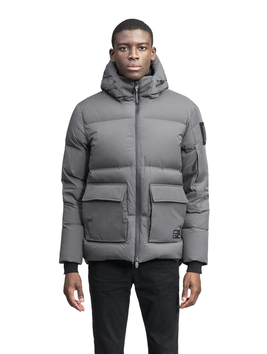 Supra Men's Performance Puffer in hip length, Technical Taffeta and 3-Ply Micro Denier fabrication, Premium Canadian White Duck Down insulation, non-removable down filled hood, centre front two-way zipper, flap pockets at waist, and zipper pocket at left bicep, in Concrete + Concrete