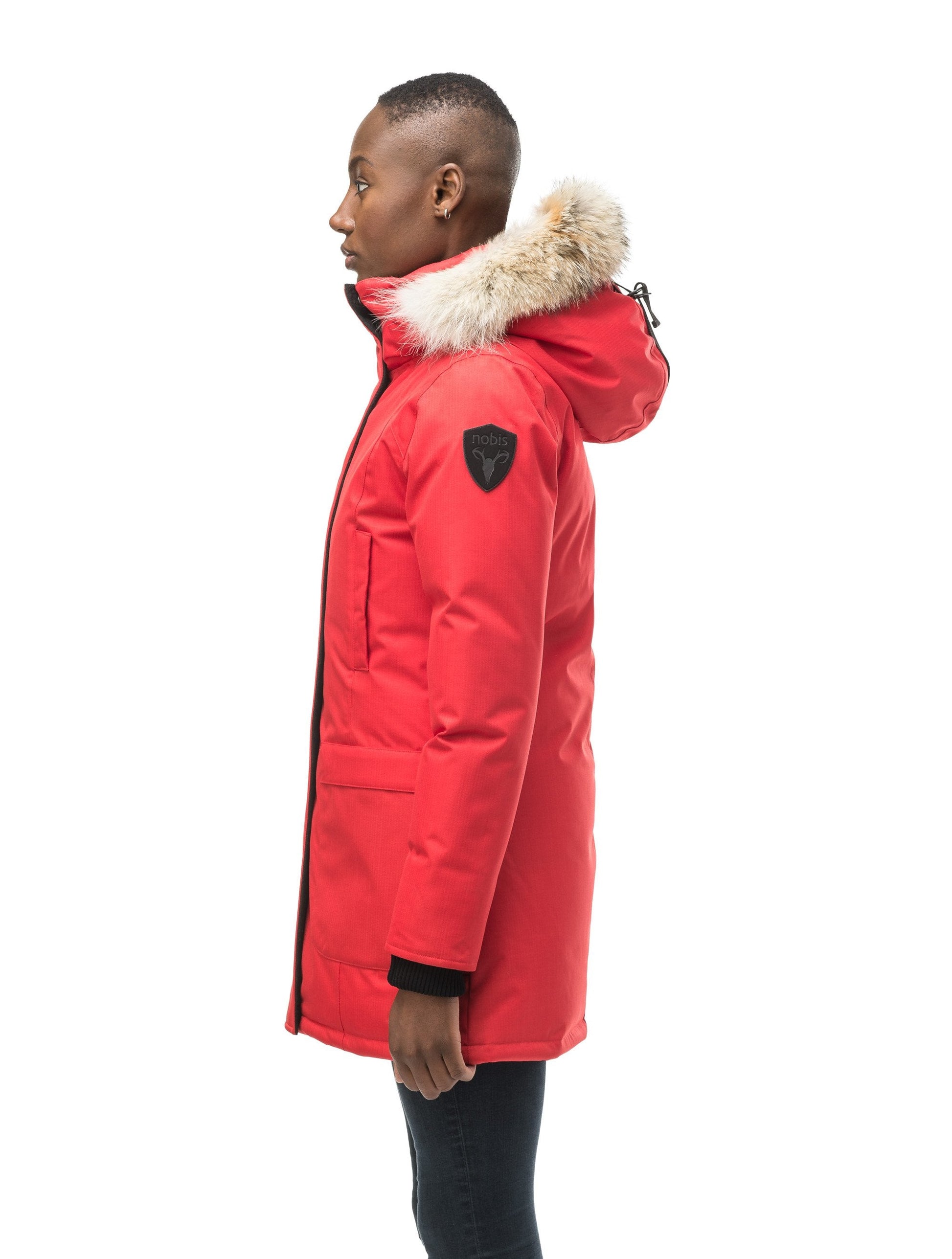 Women's down filled parka that sits just below the hip with a clean look and two hip patch pockets in CH Red