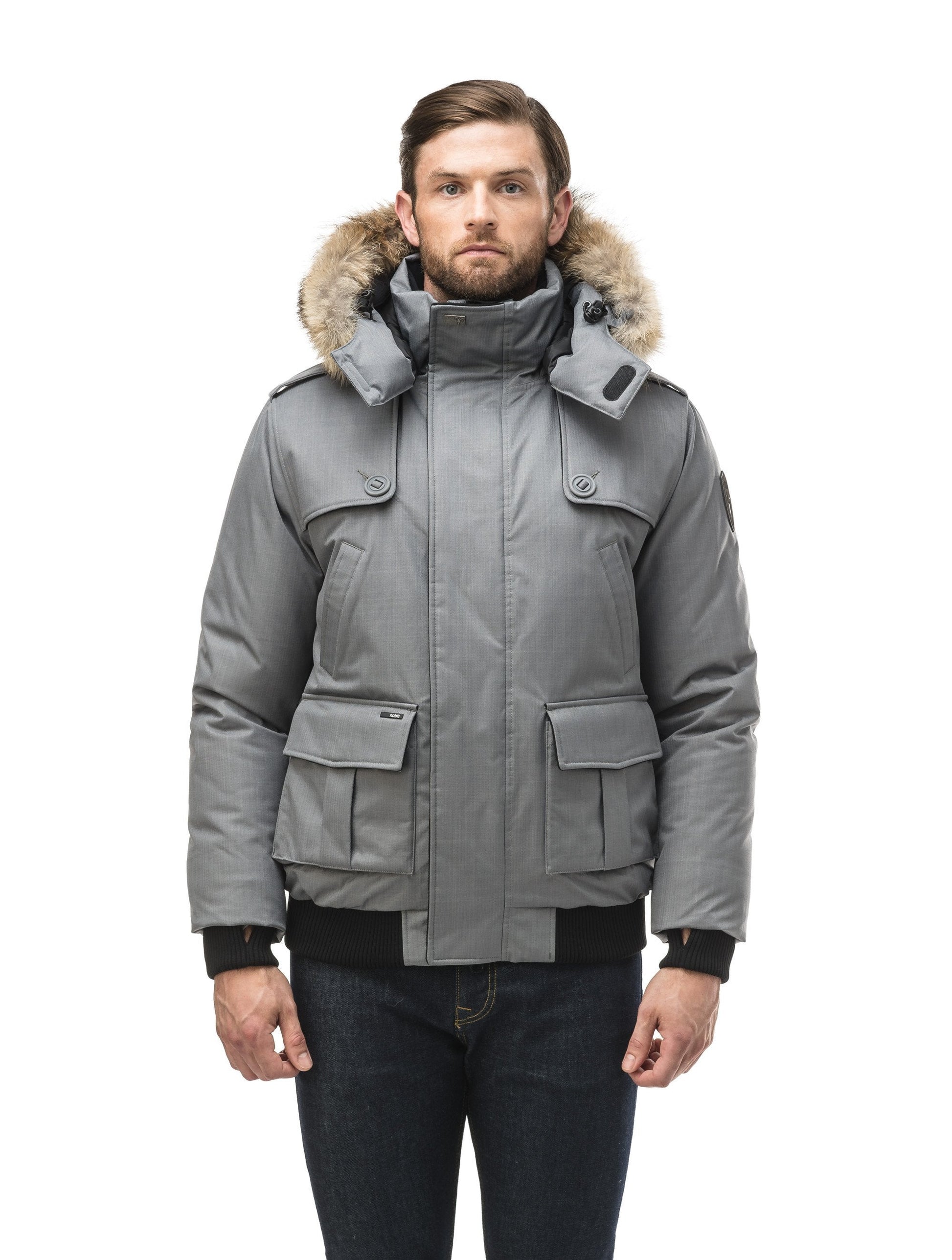 Men's down filled bomber that sits just above the hips with a completely removable hood that's windproof, waterproof, and breathable in CH Concrete