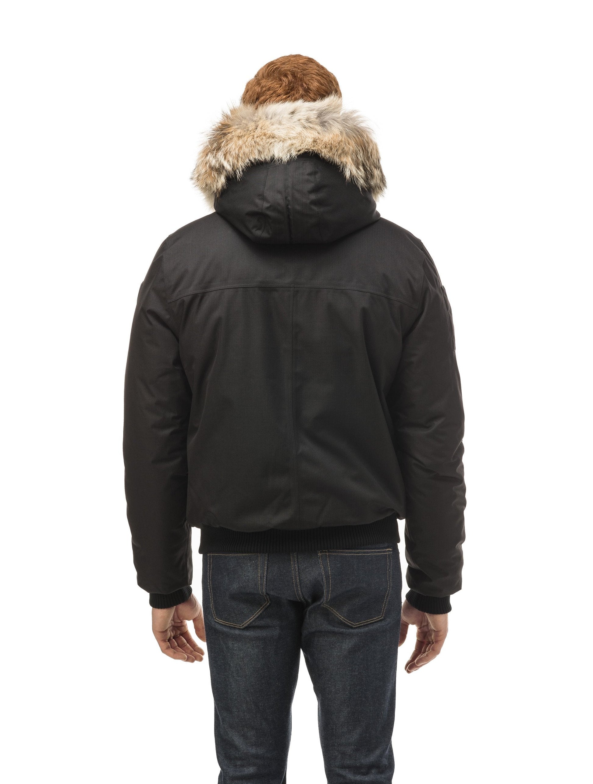Men's classic down filled bomber jacket with a down filled hood that features a removable coyote fur trim and concealed moldable framing wire in Black