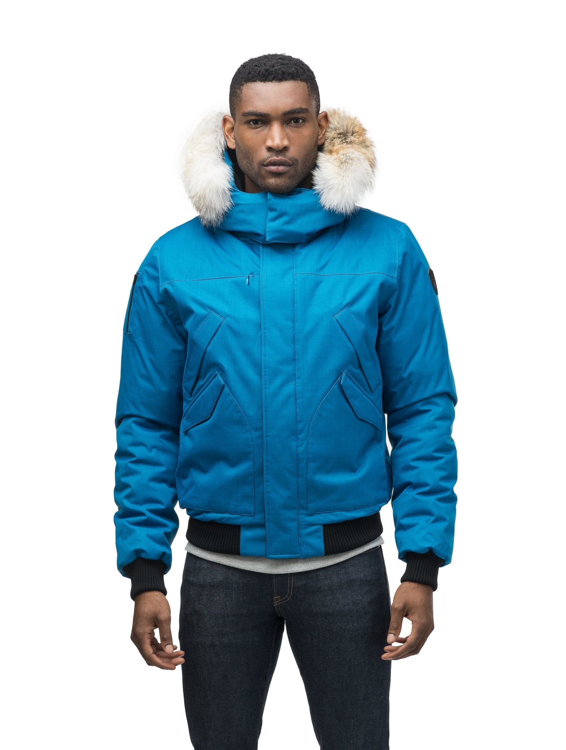 Men's classic down filled bomber jacket with a down filledÂ hood that features a removable coyote fur trim and concealed moldable framing wire in Sea Blue