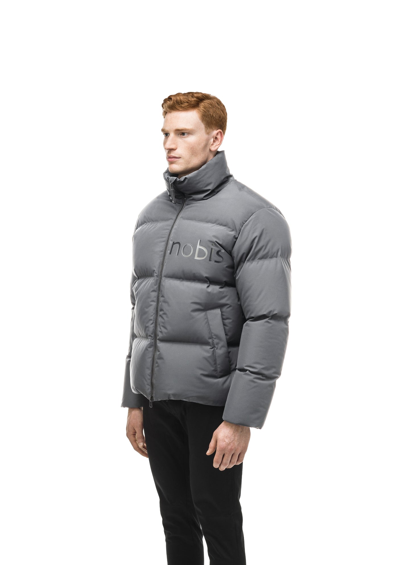 Men's puffer jacket with a minimalist modern design; featuring graphic details like oversized tonal branding, an exposed zipper, and seamless puffer channels in Concrete