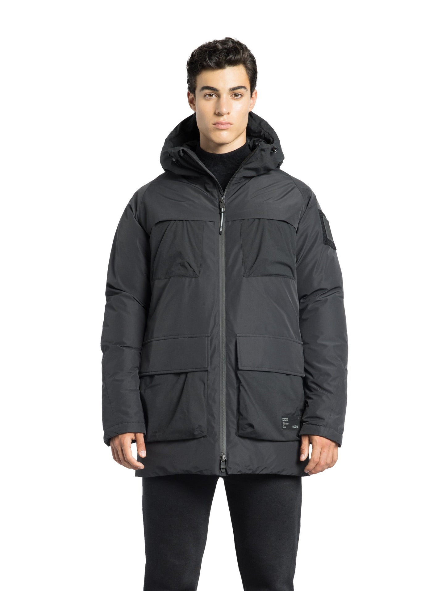 Ronin Men's Performance Utility Jacket in thigh length, premium 3-ply micro denier and stretch ripstop fabrication, Premium Canadian origin White Duck Down insulation, non-removable down-filled hood, bellow chest pockets, magnetic closure waist flap pockets, two-way centre-front zipper, pit zipper vents, hidden adjustable waist drawcord, in Black