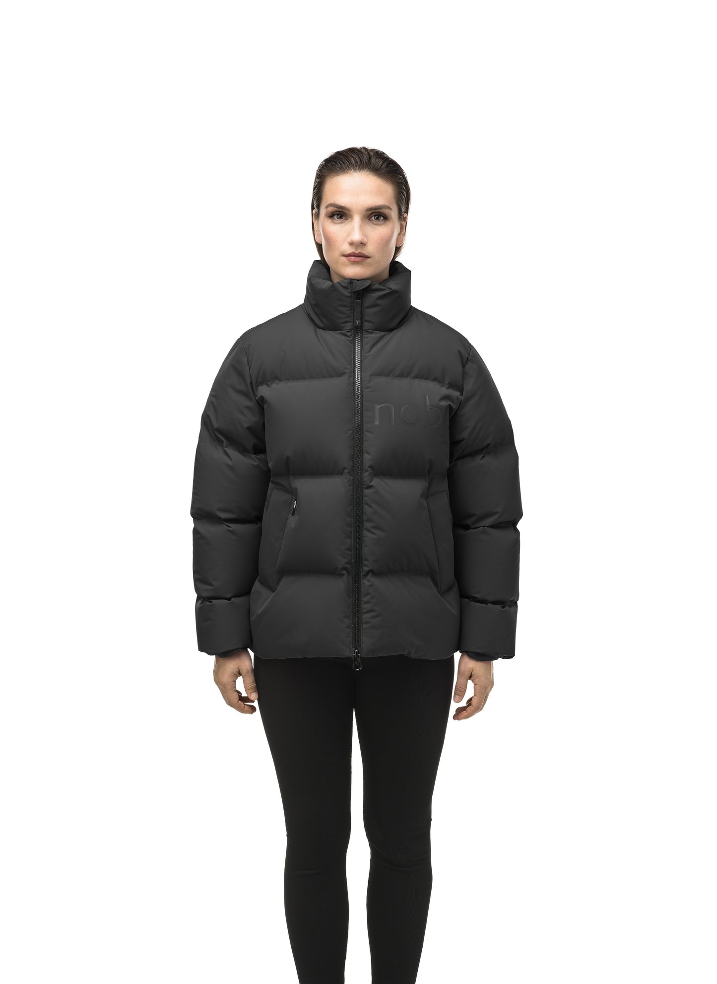 Women's puffer jacket with a minimalist modern design; featuring graphic details like oversized tonal branding, an exposed zipper, and seamless puffer channels to lock in the Premium Canadian Origin White Duck Down in Black