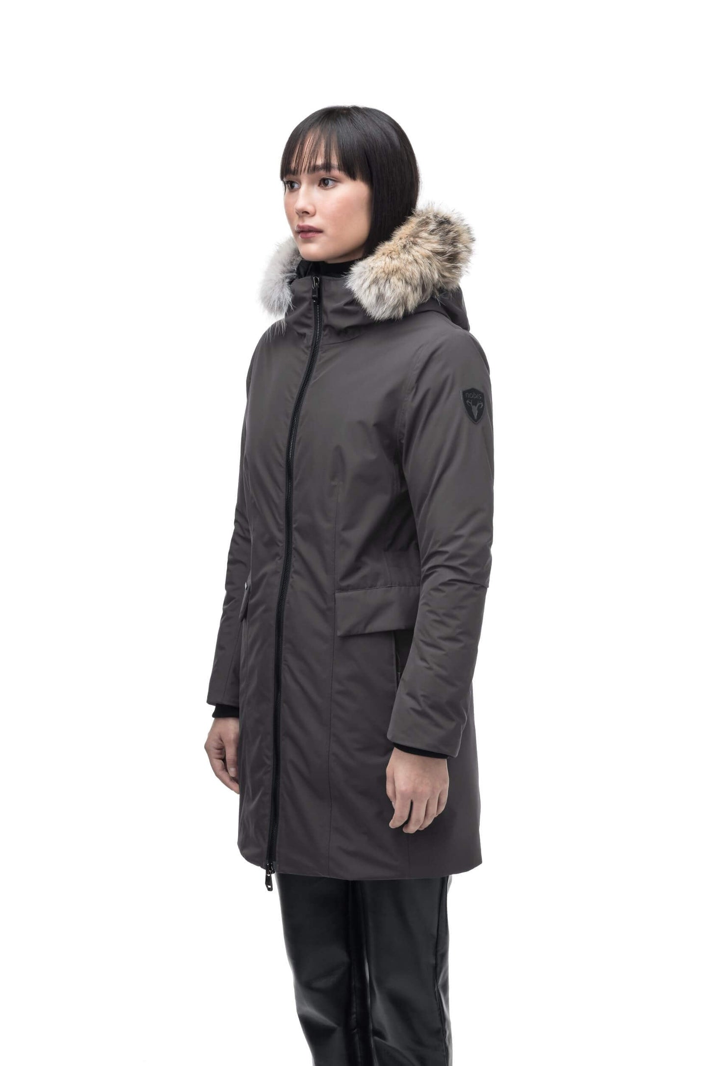 Romeda Ladies Mid Thigh Parka in thigh length, Canadian duck down insulation, non-removable hood with removable fur ruff trim, and two-way front zipper, in Steel Grey