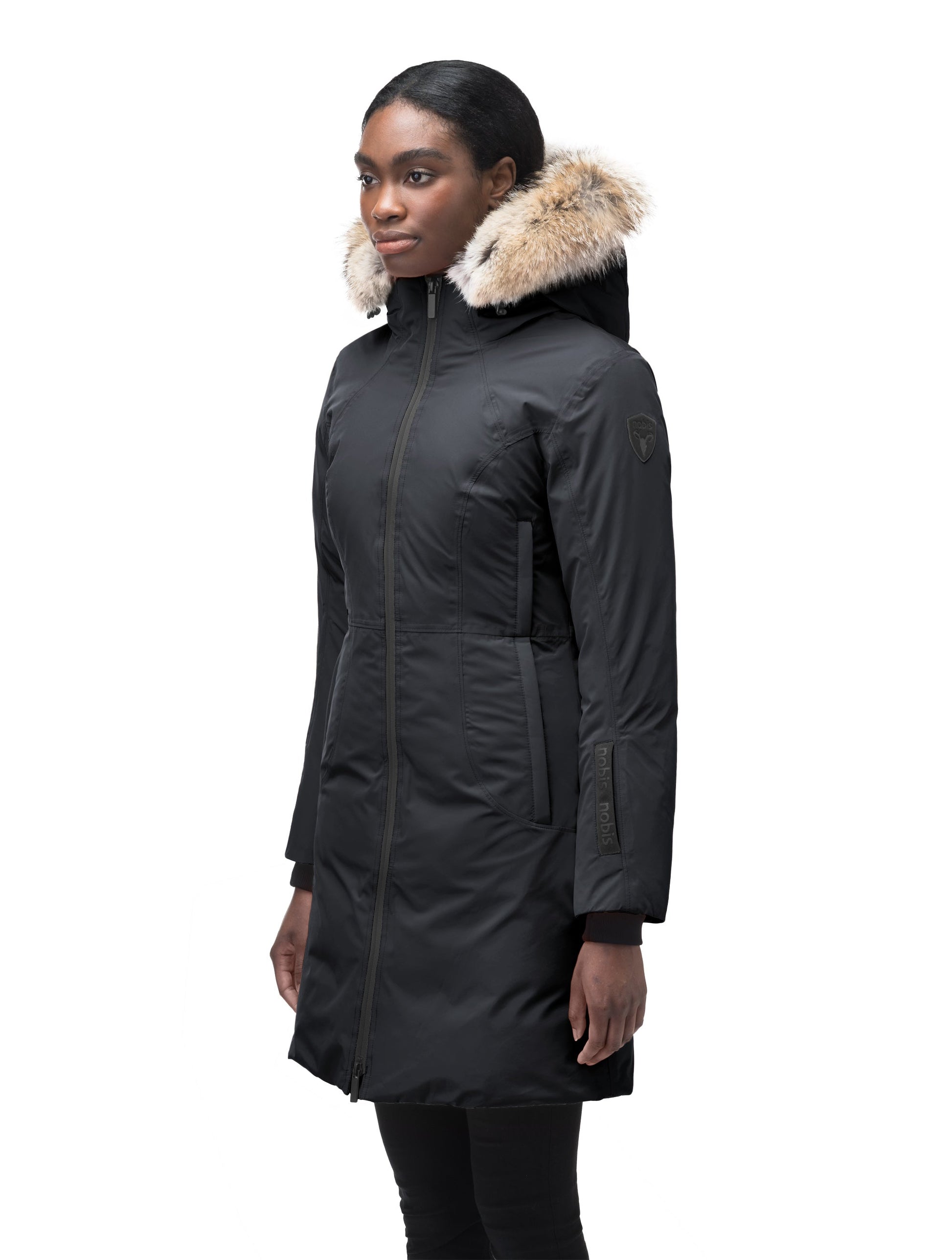 Ladies thigh length down-filled parka with non-removable hood and removable coyote fur trim in Black
