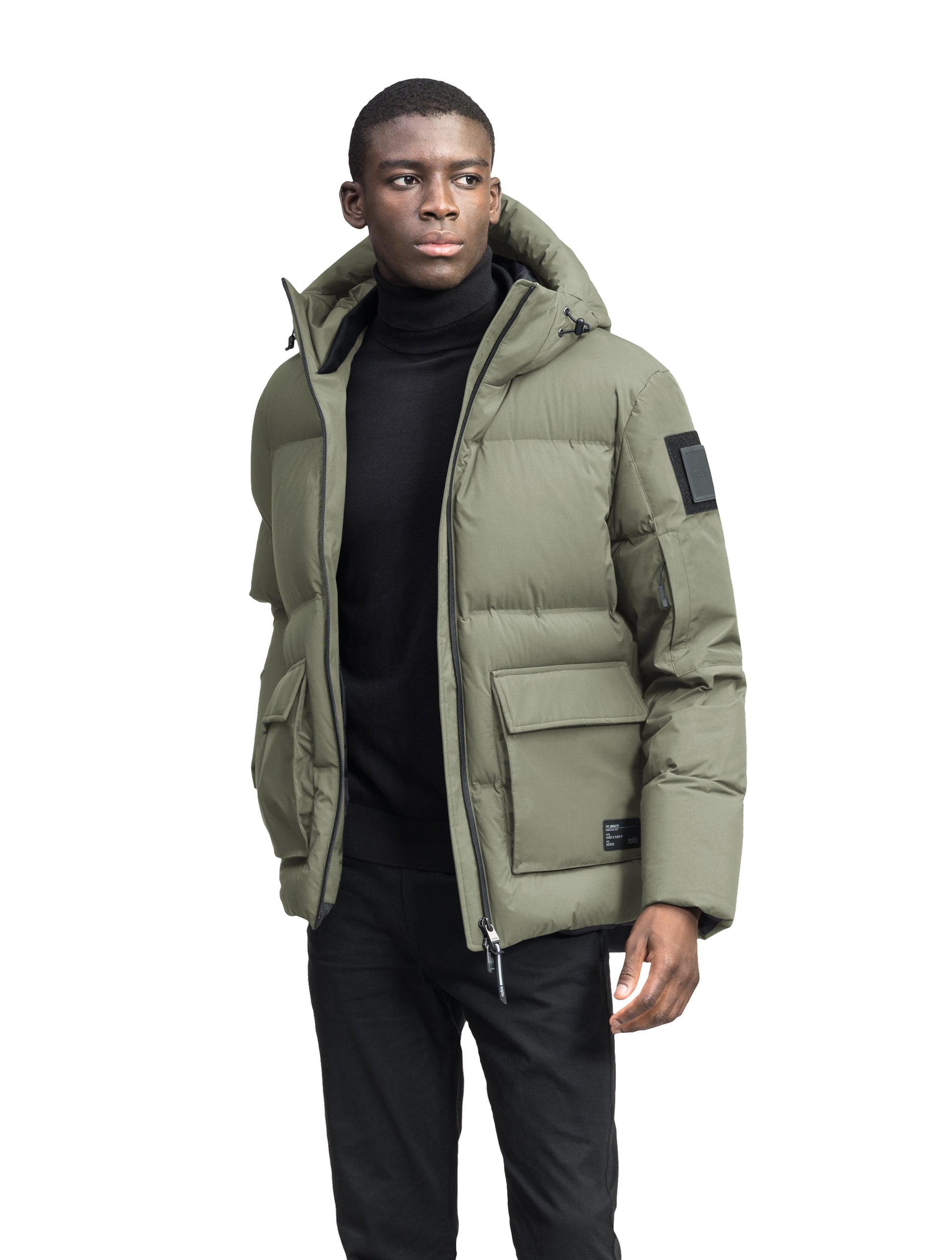 Supra Men's Performance Puffer in hip length, Technical Taffeta and 3-Ply Micro Denier fabrication, Premium Canadian White Duck Down insulation, non-removable down filled hood, centre front two-way zipper, flap pockets at waist, and zipper pocket at left bicep, in Clove