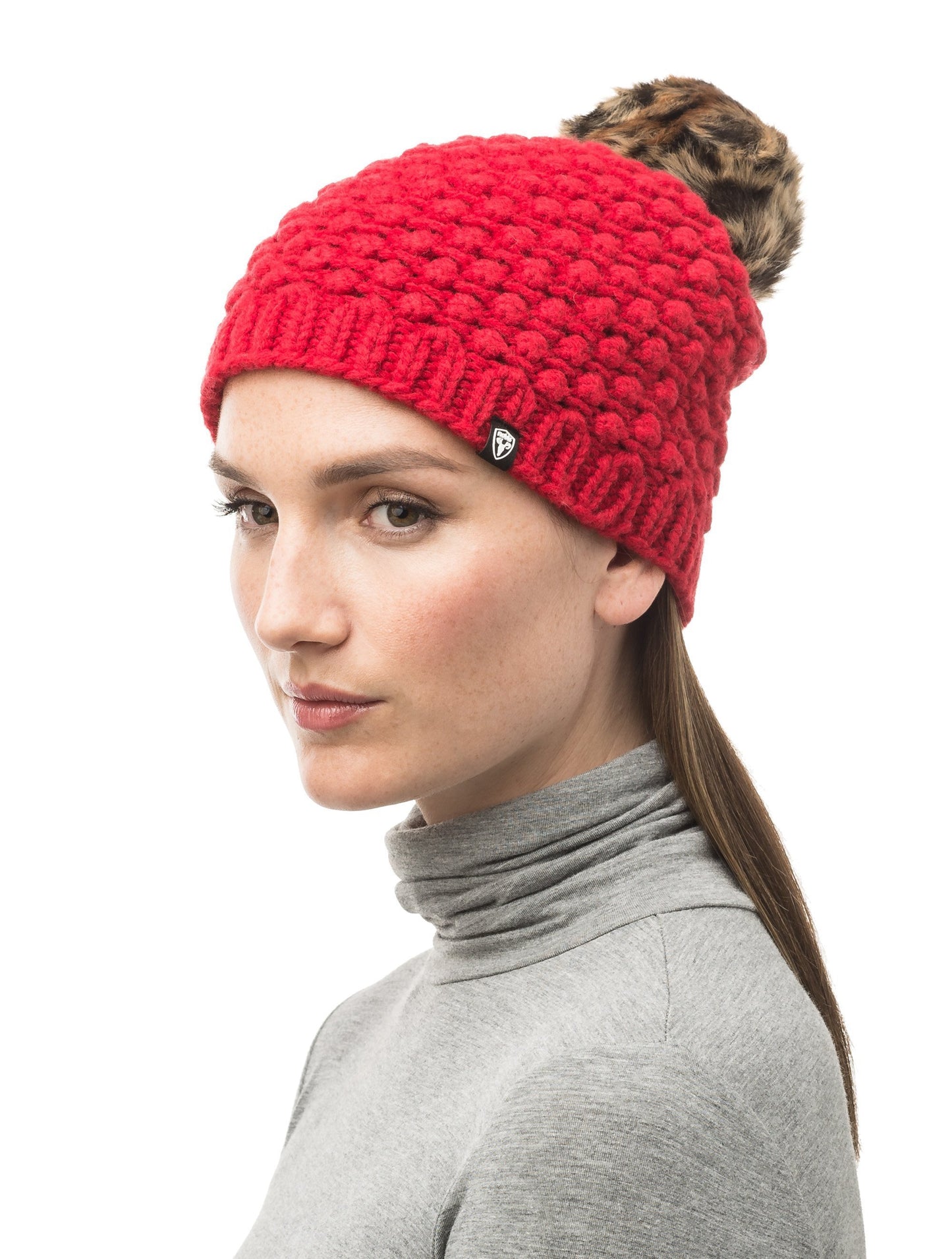 Red bulk knit toque with faux fur pom pom on top